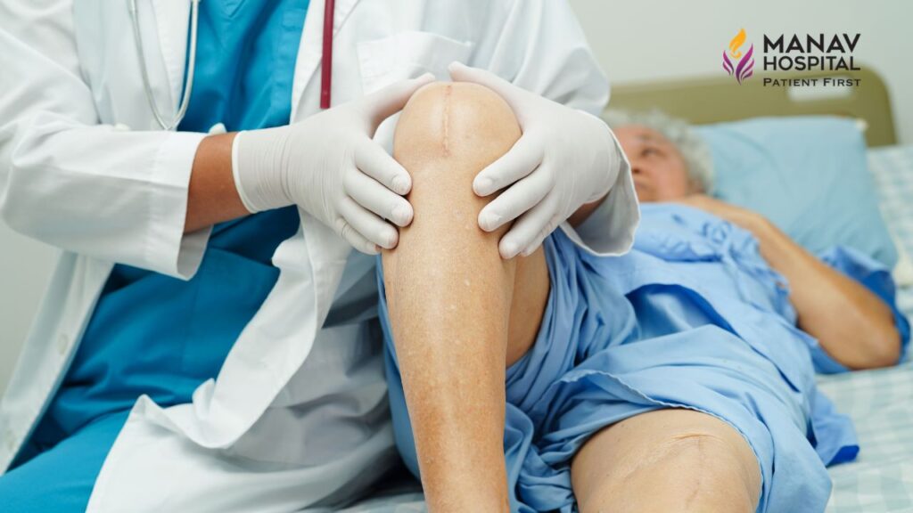 Doctor assessing knee pain X-ray at the orthopaedic hospital in Ghaziabad