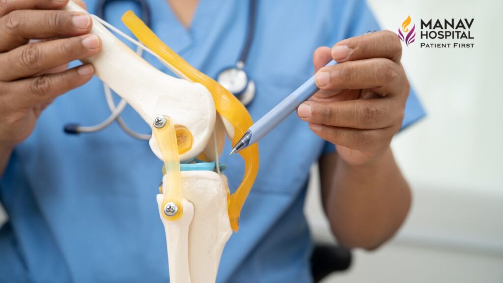 Patient walking with support after robotic knee replacement at Manav Hospital